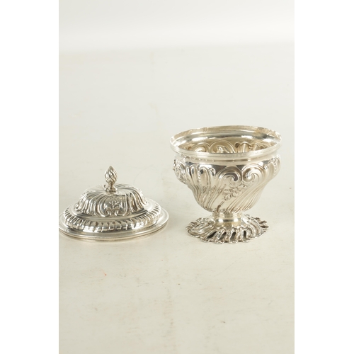 480 - A GEORGE III ROCOCO STYLE SILVER SUGAR BOWL AND COVER decorated with scrolling floral work standing ... 