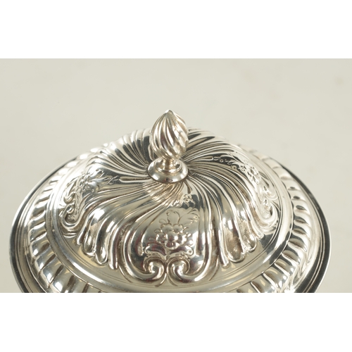 480 - A GEORGE III ROCOCO STYLE SILVER SUGAR BOWL AND COVER decorated with scrolling floral work standing ... 