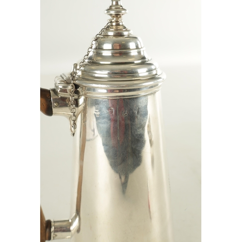 484 - A QUEEN ANNE SILVER CHOCOLATE POT with tapering body, shield decoration, conical stepped lids and si... 