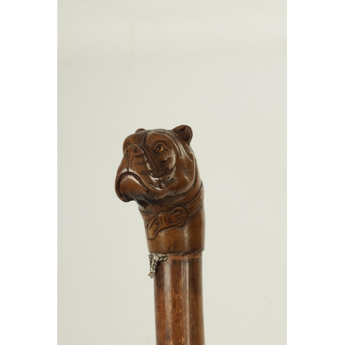 489 - A LATE 19TH CENTURY BAMBOO AND CARVED DOGS HEAD WALKING STICK with bulldog handle having glass eyes ... 