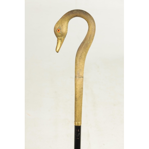 494 - A LATE 19TH CENTURY GILT METAL SWAN'S HEAD WALKING STICK with crook handle having glass eyes and mou... 