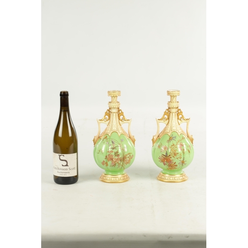 50 - A FINE AND UNUSUAL PAIR OF ROYAL WORCESTER CABINET VASES the sage green lobed panelled bodies finely... 