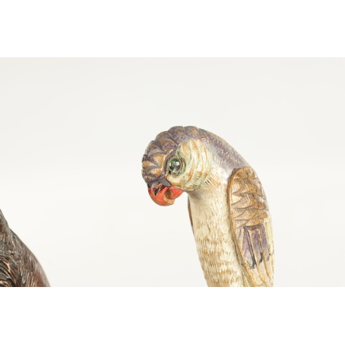 501 - TWO LATE 19TH CENTURY CARVED WOOD WALKING STICKS one modelled as a parrot painted in polychrome colo... 