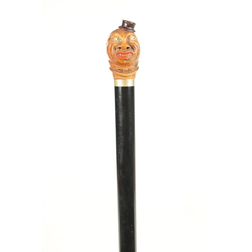 507 - A LATE 19TH CENTURY CARVED BOX WOOD CARICATURE HEAD WALKING STICK moulded as a man wearing a hat wit... 