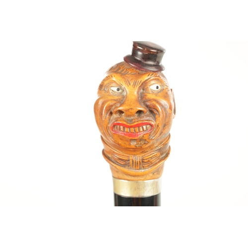 507 - A LATE 19TH CENTURY CARVED BOX WOOD CARICATURE HEAD WALKING STICK moulded as a man wearing a hat wit... 