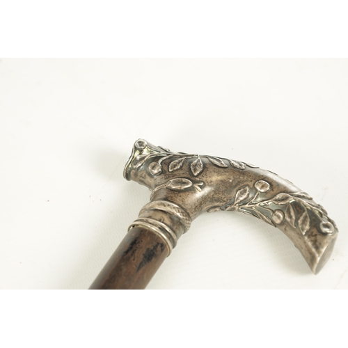 508 - A LATE 19TH CENTURY FRENCH SILVER TOPPED WALKING STICK with leaf and snake moulded top above an ebon... 