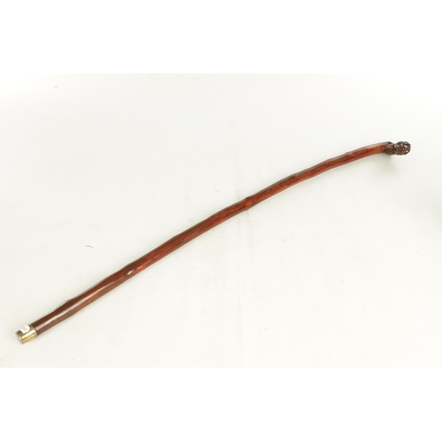 509 - AN EARLY 19TH CENTURY FOLK ART CARVED WALKING STICK the stained branch work shaft with a carved man'... 