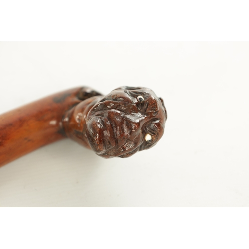 509 - AN EARLY 19TH CENTURY FOLK ART CARVED WALKING STICK the stained branch work shaft with a carved man'... 