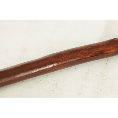 509 - AN EARLY 19TH CENTURY FOLK ART CARVED WALKING STICK the stained branch work shaft with a carved man'... 