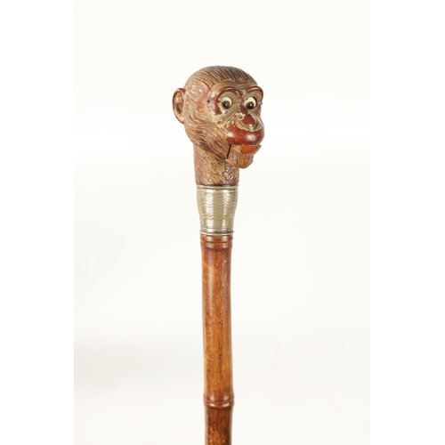 511 - A LATE 19TH CENTURY NOVELTY WALKING STICK FORMED AS A MONKEY HEAD WITH AUTOMATON EYES AND MOUTH fitt... 