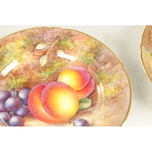 55 - A PAIR OF MID 20TH CENTURY ROYAL WORCESTER CABINET PLATES PAINTED WITH FRUIT signed Freeman with bla... 