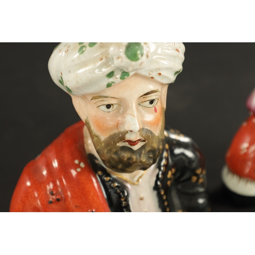 63 - A PAIR OF 19TH CENTURY FIGURAL STAFFORDSHIRE VASES modelled as Abdul Karim and Queen Victoria. (13cm... 