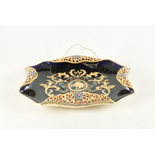 64 - A LATE 19TH CENTURY CERAMIC DISH POSSIBLY HUNGARIAN with armorial Lions head centre and pierced flor... 