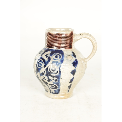 66 - A 19TH CENTURY WESTERWALD GERMAN STONEWARE JUG with blue highlighted incised floral decorations encl... 