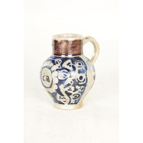 66 - A 19TH CENTURY WESTERWALD GERMAN STONEWARE JUG with blue highlighted incised floral decorations encl... 