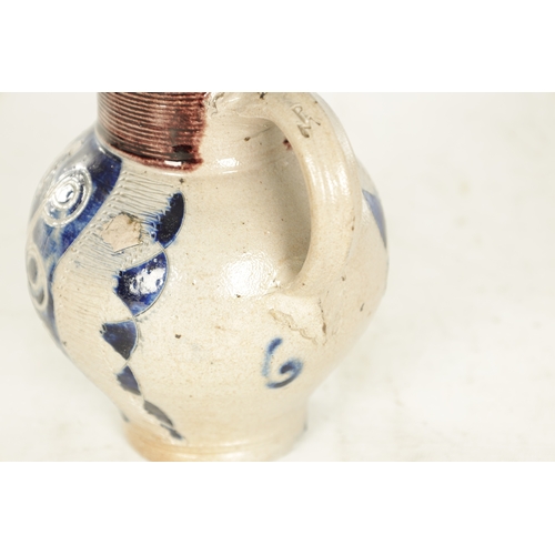 66 - A 19TH CENTURY WESTERWALD GERMAN STONEWARE JUG with blue highlighted incised floral decorations encl... 