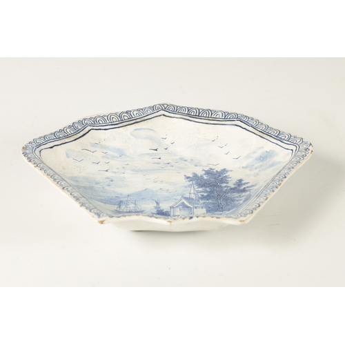 80 - AN 18TH/19TH CENTURY DELFT BLUE AND WHITE SHAPED SHALLOW DISH with lake and landscape centre depicti... 