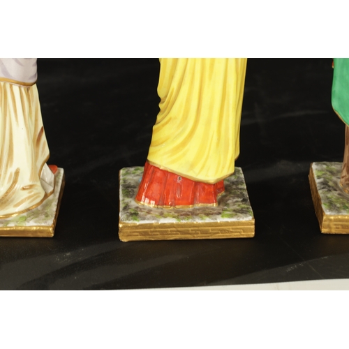 97 - A SET OF FOUR DRESDEN CLASSICAL MAIDEN FIGURES brightly coloured and stamped beneath. (24cm high and... 