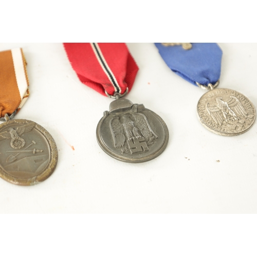 519 - A COLLECTION OF FOUR WWII GERMAN NAZI MEDALS comprising of a West Wall Medal, a Winter Campaign Meda... 