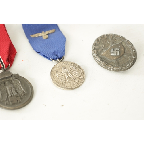 519 - A COLLECTION OF FOUR WWII GERMAN NAZI MEDALS comprising of a West Wall Medal, a Winter Campaign Meda... 