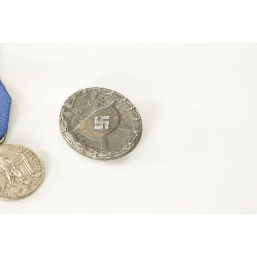 519 - A COLLECTION OF FOUR WWII GERMAN NAZI MEDALS comprising of a West Wall Medal, a Winter Campaign Meda... 