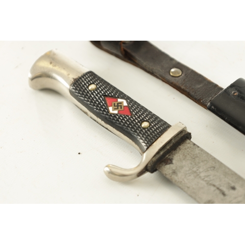 532 - A WORLD WAR II GERMAN NAZI HITLER YOUTH DAGGER with checkered grip set with an enamel swastika badge... 