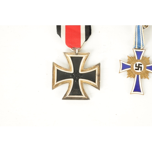 547 - THREE WWII GERMAN NAZI MEDALS AND AN EMBROIDERED INSIGNIA the medals comprising of an enamel Hitler ... 