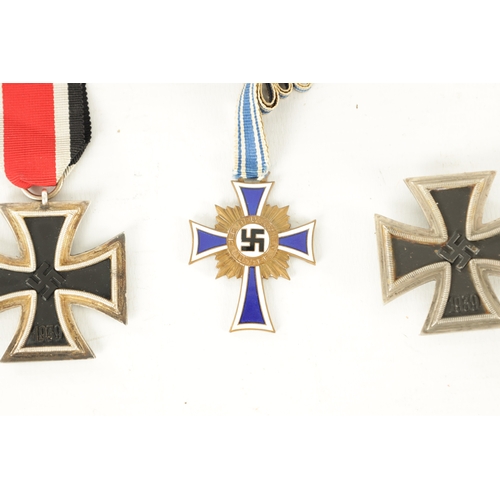 547 - THREE WWII GERMAN NAZI MEDALS AND AN EMBROIDERED INSIGNIA the medals comprising of an enamel Hitler ... 