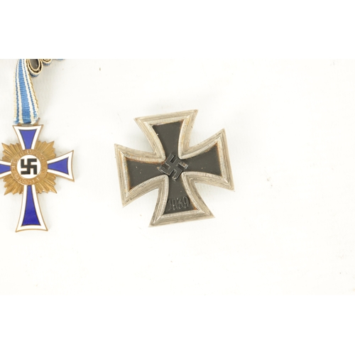 547 - THREE WWII GERMAN NAZI MEDALS AND AN EMBROIDERED INSIGNIA the medals comprising of an enamel Hitler ... 