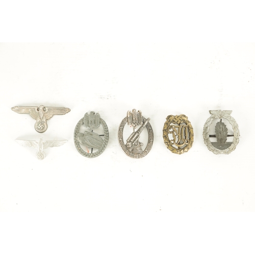 557 - A COLLECTION OF SIX WWII NAZI GERMAN BADGES comprising of two Eagle cap badges, a bronze Sports badg... 