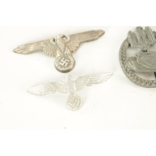 557 - A COLLECTION OF SIX WWII NAZI GERMAN BADGES comprising of two Eagle cap badges, a bronze Sports badg... 