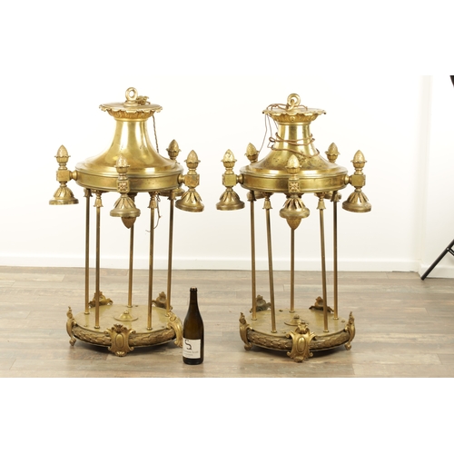 604 - A LARGE PAIR OF EDWARDIAN GILT BRASS HANGING LANTERNS with shaped tops and pineapple finials each ha... 