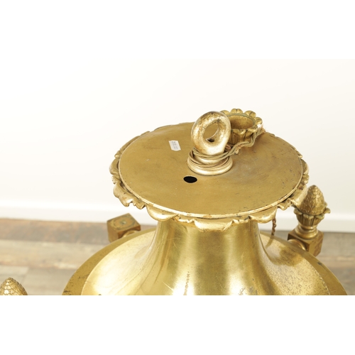 604 - A LARGE PAIR OF EDWARDIAN GILT BRASS HANGING LANTERNS with shaped tops and pineapple finials each ha... 