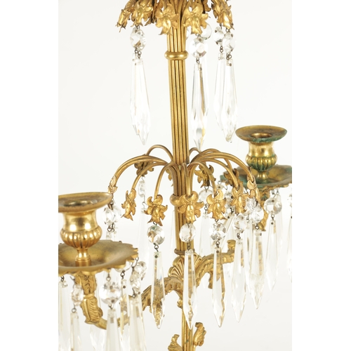 606 - A 19TH CENTURY FRENCH BRONZE AND ORMOLU THREE PIECE CANDELABRA GARNITURE, the centrepiece with cut g... 