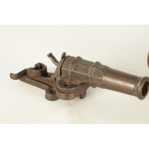 607 - A 19TH CENTURY BRONZE MODEL OF A STARTER CANNON on cast brass carriage TOGETHER WITH A CAST IRON STA... 