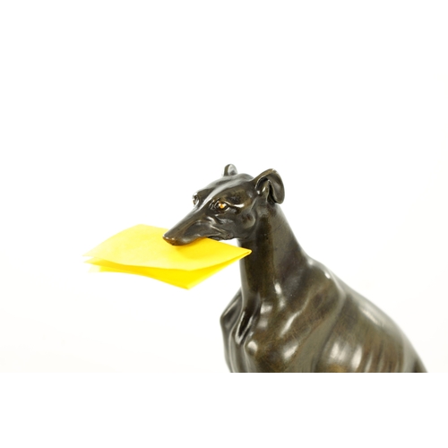 617 - A REGENCY PATINATED BRONZE DESK TIDY FORMED AS A SEATED GREY HOUND with a sprung mouth for paper rai... 