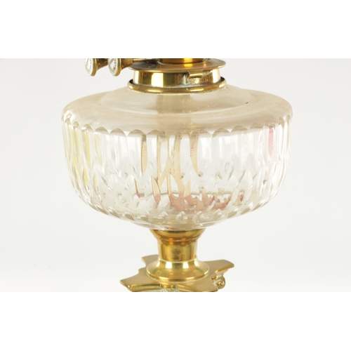 623 - A COLLECTION OF THREE 19TH CENTURY OIL LAMPS, having brass columns on square bases, two with glass c... 