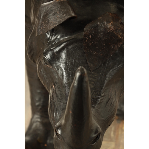 628 - A LARGE LIBERTY STYLE LEATHER BOUND MODEL OF A RHINO (140cm wide 52cm wide)