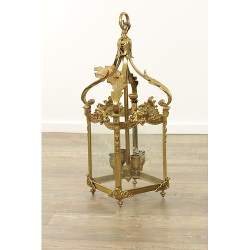 632 - A LATE 19TH CENTURY GILT BRASS SQUARE HANGING LANTERN with acanthus leaf shaped arms above masked ri... 