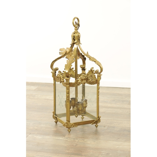 632 - A LATE 19TH CENTURY GILT BRASS SQUARE HANGING LANTERN with acanthus leaf shaped arms above masked ri... 