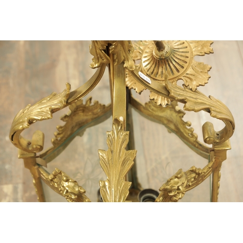 632 - A LATE 19TH CENTURY GILT BRASS SQUARE HANGING LANTERN with acanthus leaf shaped arms above masked ri... 