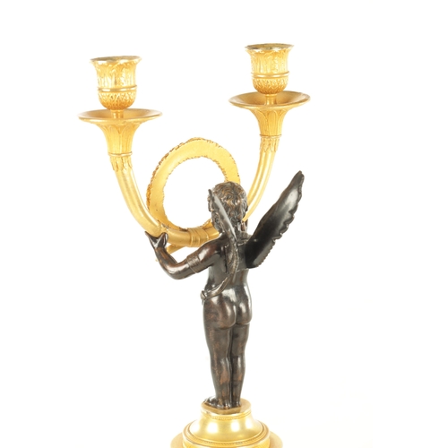 636 - A PAIR OF REGENCY STYLE TWO BRANCH BRONZE AND CAST BRASS WINGED CHERUB CANDLESTICKS (42cm high)