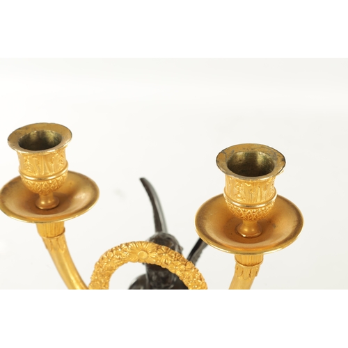 636 - A PAIR OF REGENCY STYLE TWO BRANCH BRONZE AND CAST BRASS WINGED CHERUB CANDLESTICKS (42cm high)