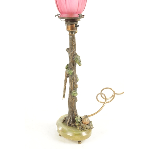 640 - AN ART NOUVEAU AUSTRIAN COLD PAINTED BRONZE TABLE LAMP AND SHADE depicting a tree and a pair of phea... 