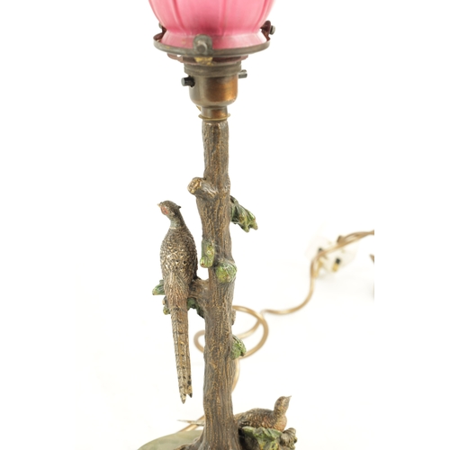 640 - AN ART NOUVEAU AUSTRIAN COLD PAINTED BRONZE TABLE LAMP AND SHADE depicting a tree and a pair of phea... 