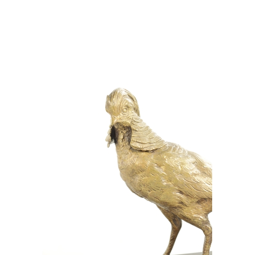 653 - A 20TH CENTURY GILT BRONZE SCULPTURE OF A GOLDEN PHEASANT. depicted standing on a veined black marbl... 