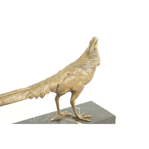 653 - A 20TH CENTURY GILT BRONZE SCULPTURE OF A GOLDEN PHEASANT. depicted standing on a veined black marbl... 