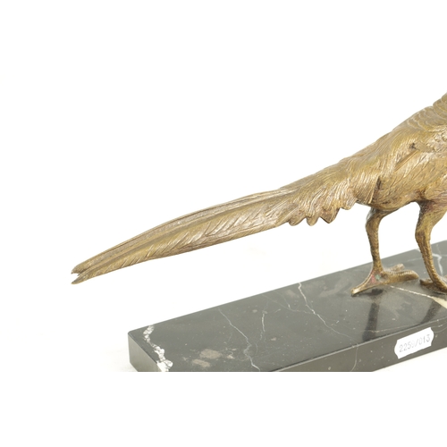 653 - A 20TH CENTURY GILT BRONZE SCULPTURE OF A GOLDEN PHEASANT. depicted standing on a veined black marbl... 