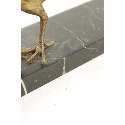 653 - A 20TH CENTURY GILT BRONZE SCULPTURE OF A GOLDEN PHEASANT. depicted standing on a veined black marbl... 