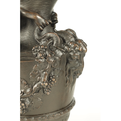 661 - A PAIR OF LATE 19TH CENTURY BRONZE EWERS OF CLASSICAL FORM with Baccus seated on the shoulder with r... 